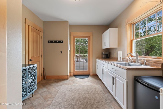 679 Comeback Bay Ln, Sagle, ID 83860 - kitchen featuring a sink, healthy amount of natural light, fridge, and white cabinetry