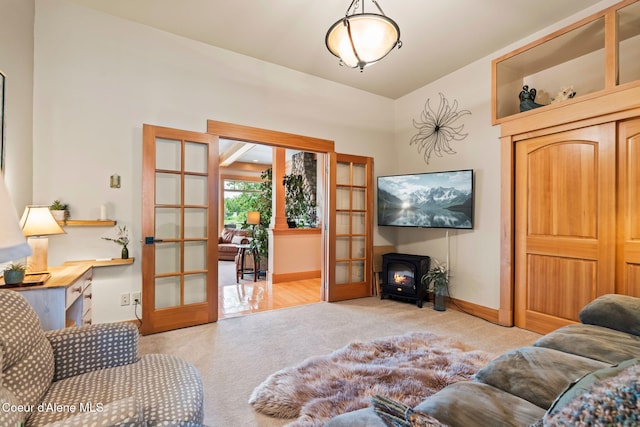 679 Comeback Bay Ln, Sagle, ID 83860 - carpeted living room with french doors, a wood stove, and baseboards
