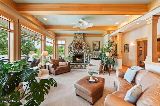 679 Comeback Bay Ln, Sagle, ID 83860 - carpeted living room with decorative columns, beamed ceiling, a ceiling fan, a fireplace, and crown molding