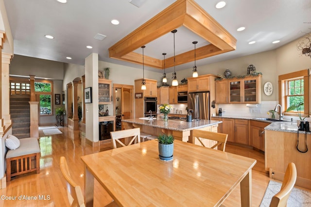 679 Comeback Bay Ln, Sagle, ID 83860 - dining space featuring a raised ceiling, light wood-style flooring, recessed lighting, and stairway