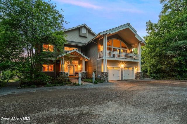 679 Comeback Bay Ln, Sagle, ID 83860 - view of front of property with a balcony, driveway, an attached garage, and stone siding