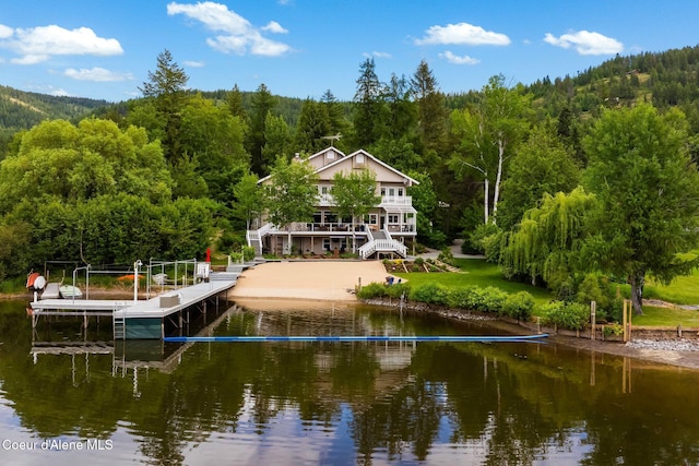 679 Comeback Bay Ln, Sagle, ID 83860 - rear view of house featuring a forest view, a water view, and boat lift