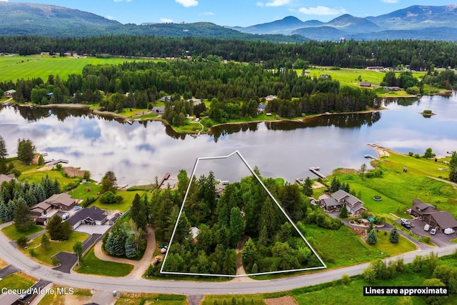 679 Comeback Bay Ln, Sagle, ID 83860 - aerial view of property and surrounding area featuring a water and mountain view, a heavily wooded area, and property boundaries highlighted