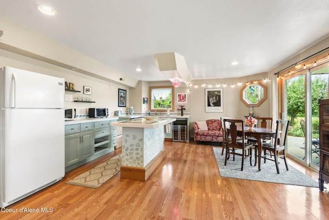 679 Comeback Bay Ln, Sagle, ID 83860 - kitchen with white appliances, wine cooler, light countertops, light wood-style floors, and recessed lighting