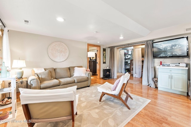 679 Comeback Bay Ln, Sagle, ID 83860 - living area featuring a wood stove, light wood-type flooring, and recessed lighting