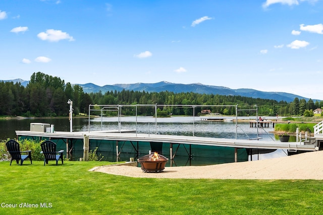 679 Comeback Bay Ln, Sagle, ID 83860 - view of community with an outdoor fire pit, a water and mountain view, a view of trees, and a yard