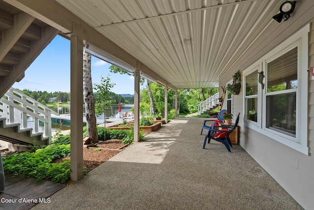 679 Comeback Bay Ln, Sagle, ID 83860 - view of patio / terrace with stairway and a water view