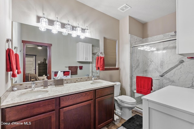 3313 N Rosalia Rd, Coeur Dalene, ID 83814 - bathroom with a marble finish shower, double vanity, and toilet