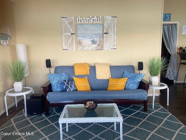 living area with wood finished floors and baseboards