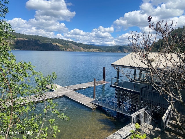 dock featuring a water view and a wooded view
