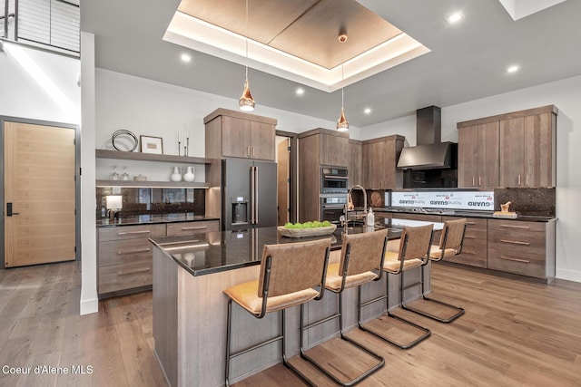 2855 W Lumber Ln, Coeur Dalene, ID 83814 - kitchen featuring high end fridge, wall chimney range hood, open shelves, a kitchen bar, and backsplash