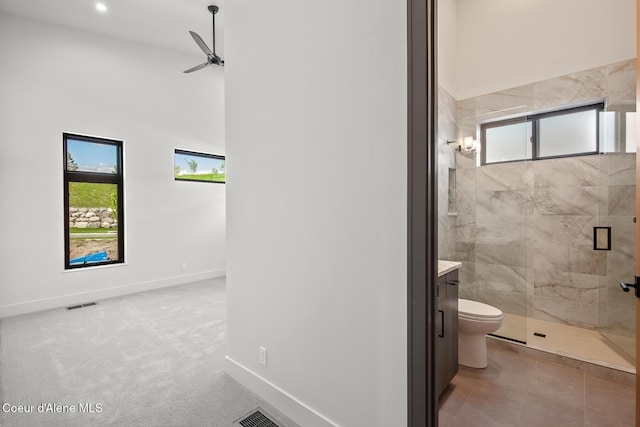 2855 W Lumber Ln, Coeur Dalene, ID 83814 - bathroom featuring a stall shower, vanity, toilet, a ceiling fan, and baseboards