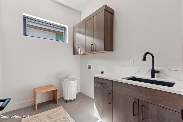 2855 W Lumber Ln, Coeur Dalene, ID 83814 - laundry area featuring washer hookup, hookup for an electric dryer, cabinet space, light tile patterned floors, and baseboards