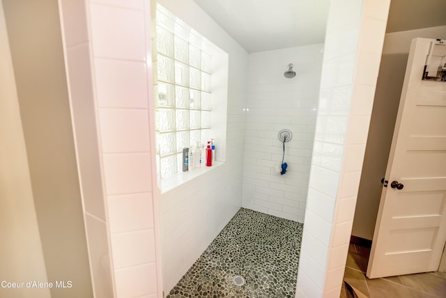 435 Shady Pines Loop, Priest Lake, ID 83856 - full bath with a tile shower, healthy amount of natural light, and tile patterned flooring