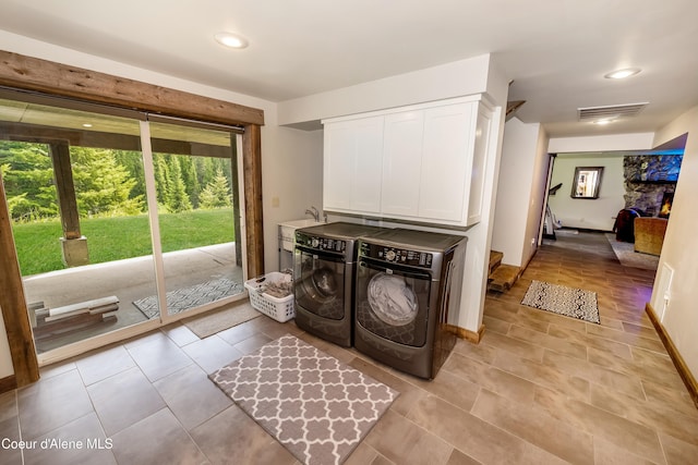 435 Shady Pines Loop, Priest Lake, ID 83856 - washroom with washing machine and dryer, cabinet space, light tile patterned flooring, recessed lighting, and baseboards