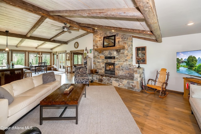 435 Shady Pines Loop, Priest Lake, ID 83856 - living room featuring wood finished floors, a stone fireplace, a ceiling fan, baseboards, and recessed lighting
