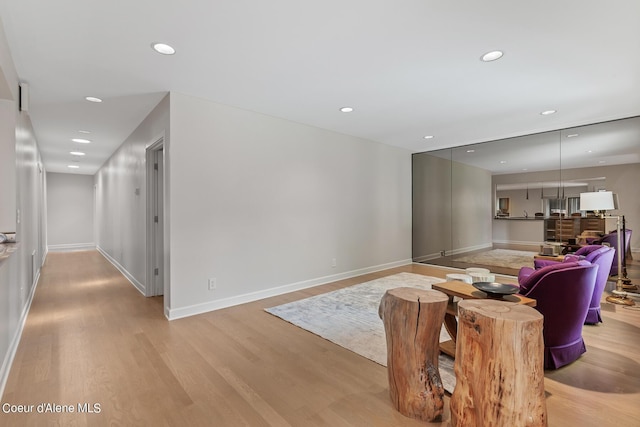 living room featuring light wood-style flooring, recessed lighting, and baseboards