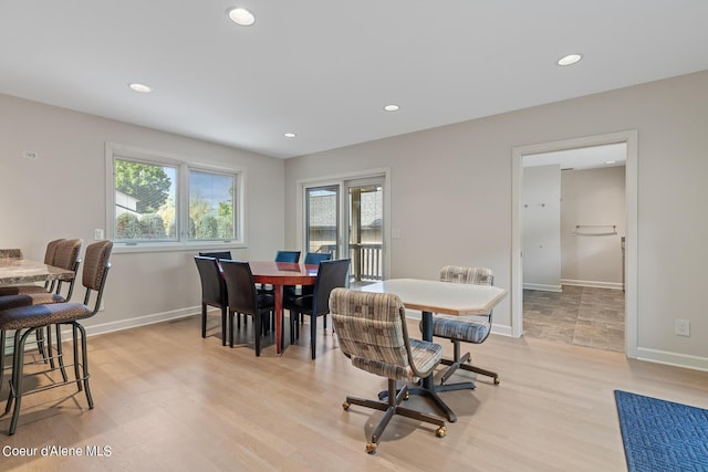 dining room featuring light wood-style floors, recessed lighting, and baseboards