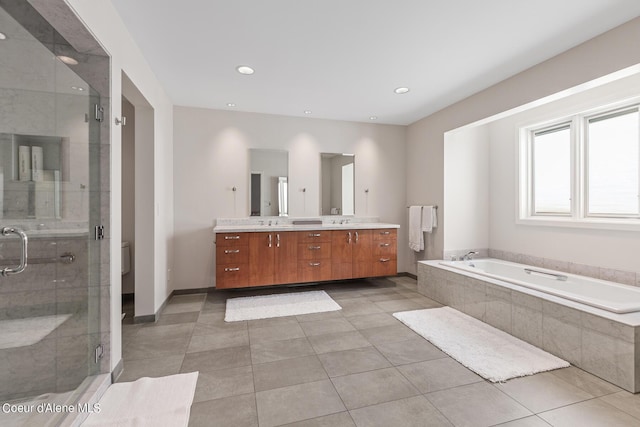 full bath featuring double vanity, a garden tub, a shower stall, tile patterned floors, and recessed lighting