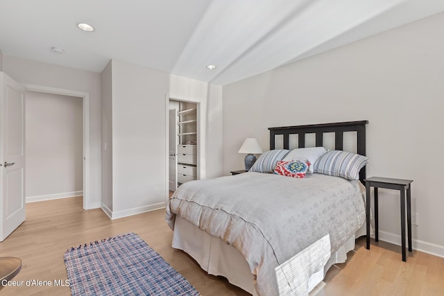 bedroom with light wood-type flooring, baseboards, and recessed lighting