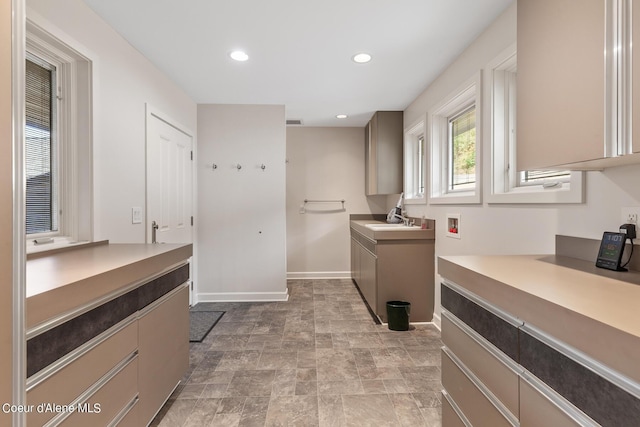 washroom with cabinet space, recessed lighting, baseboards, stone finish floors, and hookup for a washing machine