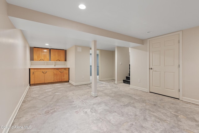 finished basement with stairs, baseboards, and recessed lighting