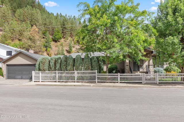 obstructed view of property with a fenced front yard