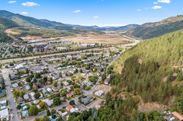 aerial view of property and surrounding area featuring a mountain backdrop
