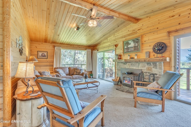 3226 District Two Rd, Bonners Ferry, ID 83805 - carpeted living room featuring wood ceiling, wooden walls, a ceiling fan, and vaulted ceiling with beams
