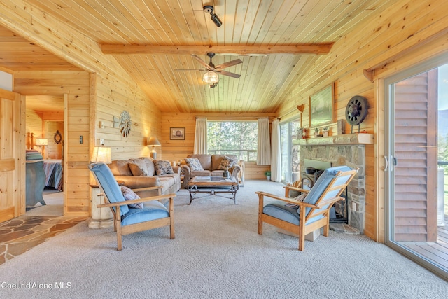 3226 District Two Rd, Bonners Ferry, ID 83805 - living area featuring wood walls, lofted ceiling with beams, carpet, wooden ceiling, and a ceiling fan