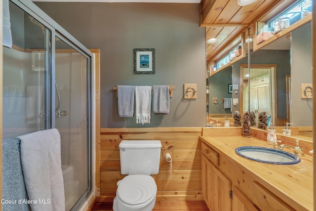 3226 District Two Rd, Bonners Ferry, ID 83805 - bathroom with a shower stall, vanity, toilet, and a wainscoted wall