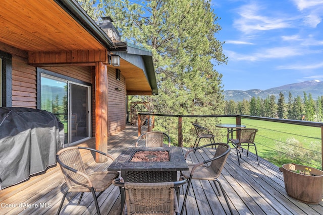 3226 District Two Rd, Bonners Ferry, ID 83805 - wooden terrace with an outdoor fire pit, area for grilling, and a mountain view