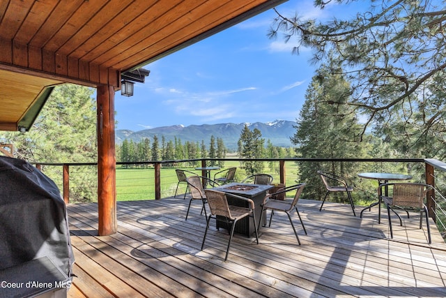 3226 District Two Rd, Bonners Ferry, ID 83805 - wooden deck with an outdoor fire pit, area for grilling, and a mountain view
