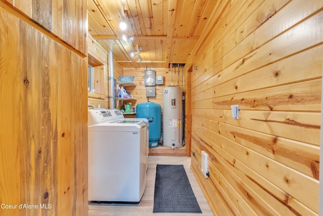 3226 District Two Rd, Bonners Ferry, ID 83805 - laundry area featuring washer and dryer, wood ceiling, water heater, light wood-type flooring, and wood walls