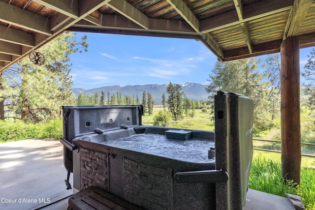 3226 District Two Rd, Bonners Ferry, ID 83805 - view of patio / terrace featuring a hot tub and a mountain view