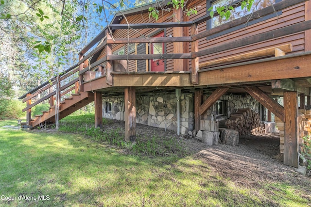3226 District Two Rd, Bonners Ferry, ID 83805 - rear view of property with stairway, stone siding, a lawn, and a deck