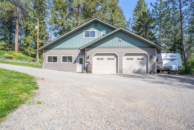3226 District Two Rd, Bonners Ferry, ID 83805 - view of front facade with an attached garage and gravel driveway