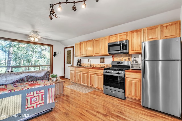 3226 District Two Rd, Bonners Ferry, ID 83805 - kitchen featuring appliances with stainless steel finishes, lofted ceiling, a ceiling fan, a sink, and light wood-style floors
