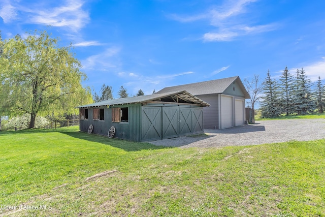 3226 District Two Rd, Bonners Ferry, ID 83805 - view of property exterior with an outdoor structure, a yard, and a detached garage
