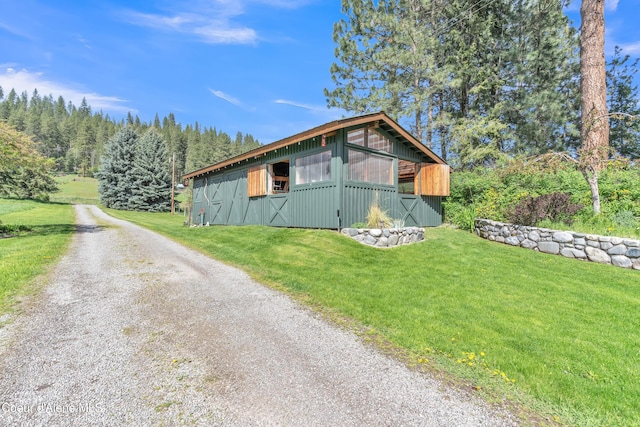 3226 District Two Rd, Bonners Ferry, ID 83805 - view of side of home with a yard, driveway, and an outdoor structure