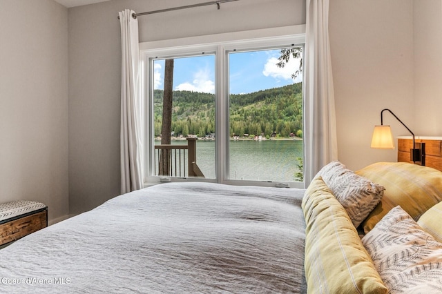 130 Cedar Shls, Sagle, ID 83860 - bedroom featuring access to outside, a water view, and a wooded view