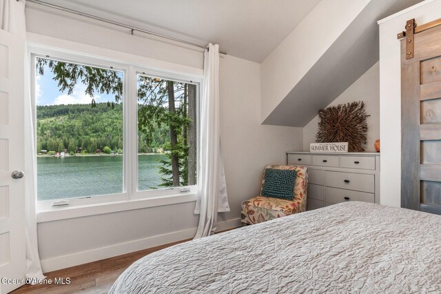 130 Cedar Shls, Sagle, ID 83860 - bedroom with wood finished floors, baseboards, and lofted ceiling