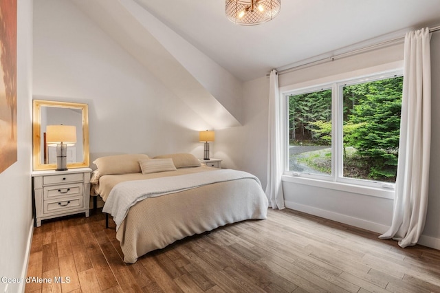 130 Cedar Shls, Sagle, ID 83860 - bedroom with vaulted ceiling, wood finished floors, and baseboards