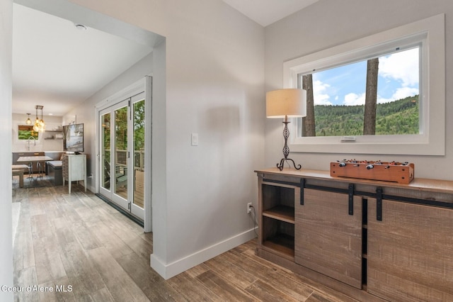 130 Cedar Shls, Sagle, ID 83860 - corridor featuring wood finished floors, baseboards, and a chandelier