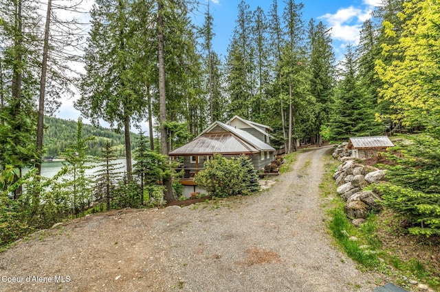 130 Cedar Shls, Sagle, ID 83860 - view of property exterior featuring driveway, a view of trees, and a water view