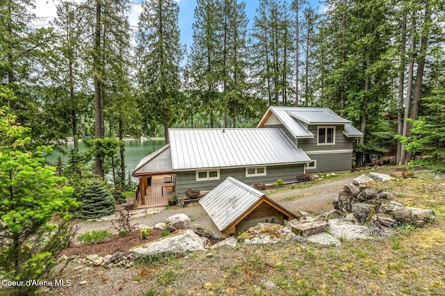 130 Cedar Shls, Sagle, ID 83860 - rear view of property featuring a water view, metal roof, and view of wooded area