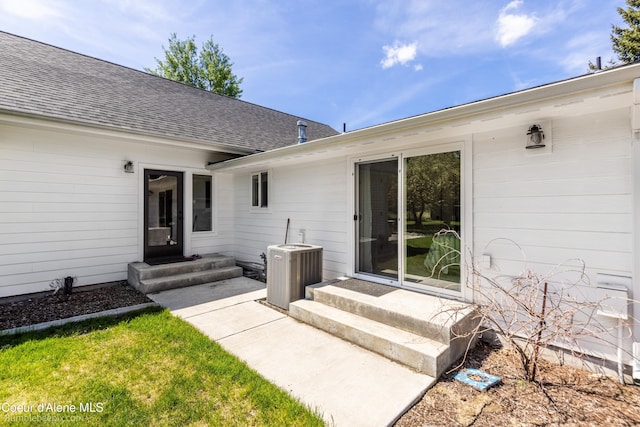 7432 N Davenport St, Dalton Gardens, ID 83815 - view of exterior entry featuring central air condition unit and a shingled roof