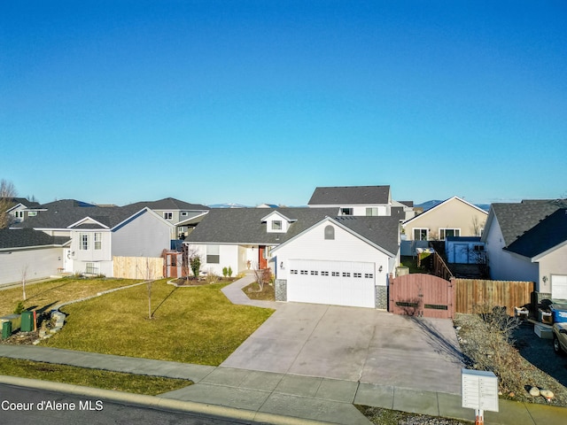 380 E Tiger Ave, Post Falls, ID 83854 - traditional-style house with a residential view, concrete driveway, a gate, and a garage