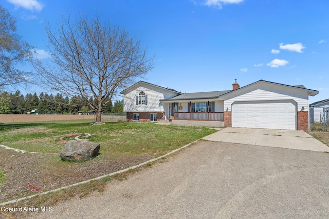 29 Silver Mountain Ln, Oldtown, ID 83822 - split level home featuring brick siding, driveway, an attached garage, a chimney, and a porch