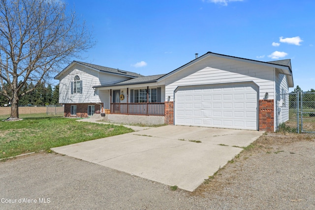 29 Silver Mountain Ln, Oldtown, ID 83822 - split level home featuring brick siding, covered porch, a garage, concrete driveway, and a gate